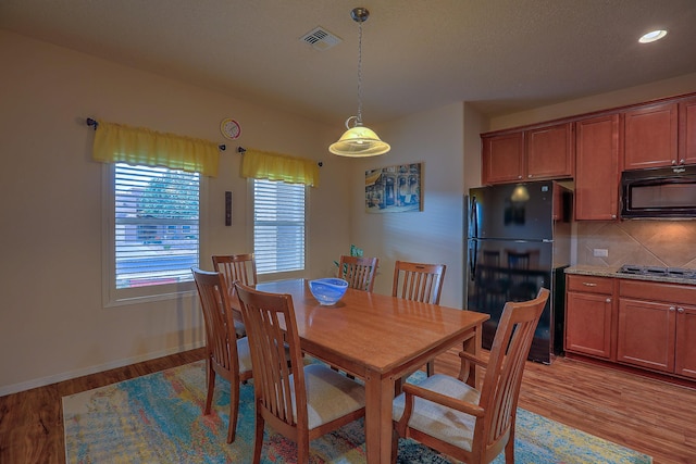 dining space with light wood-type flooring