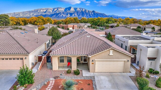 view of front of property with a mountain view and a garage