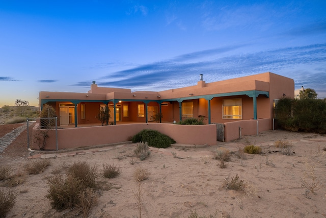 view of back house at dusk