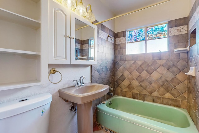 bathroom featuring toilet and tiled shower / bath