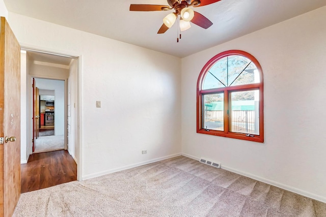 spare room with carpet flooring and ceiling fan