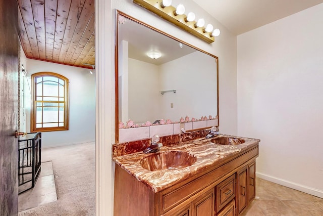 bathroom with tile patterned flooring, vanity, and wooden ceiling