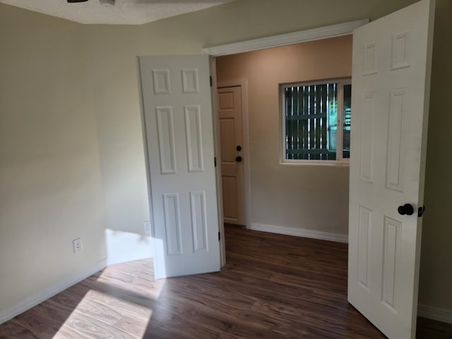 spare room featuring ceiling fan and dark hardwood / wood-style floors