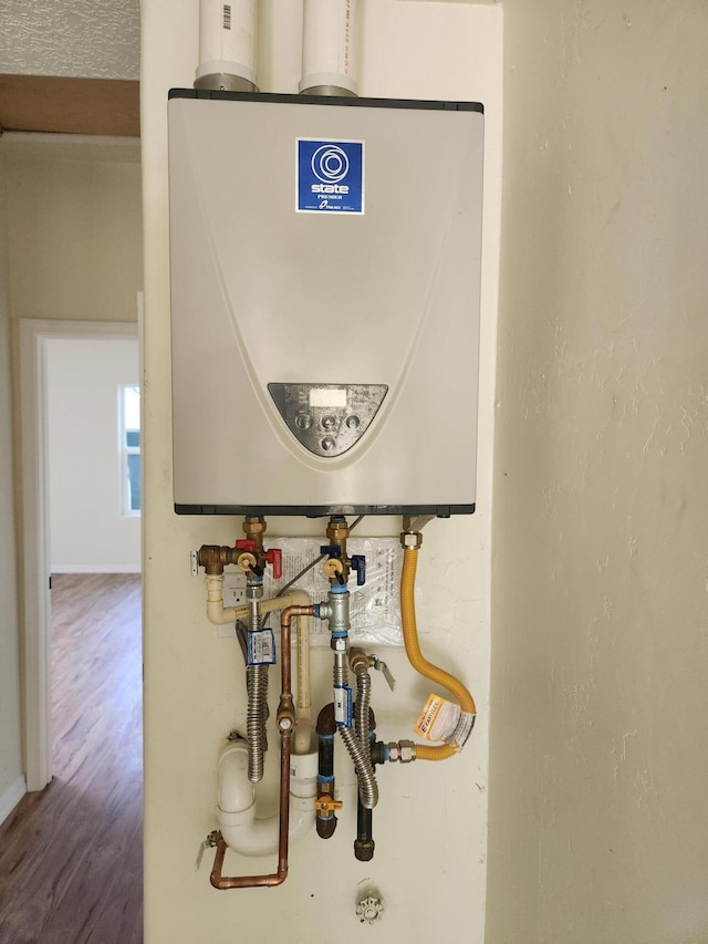 utility room featuring tankless water heater