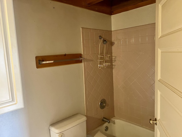 bathroom featuring shower / tub combination and toilet