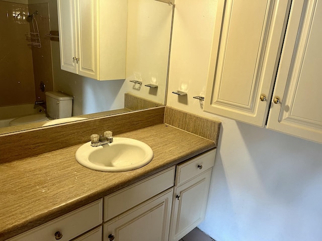 bathroom featuring  shower combination, vanity, and toilet