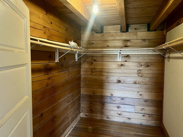 walk in closet featuring beam ceiling