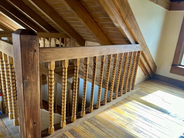 stairway with hardwood / wood-style floors, wood ceiling, and beamed ceiling