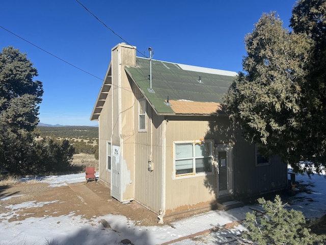 view of property exterior with a chimney