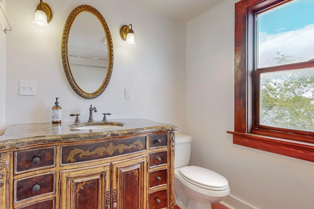 bathroom with toilet and vanity