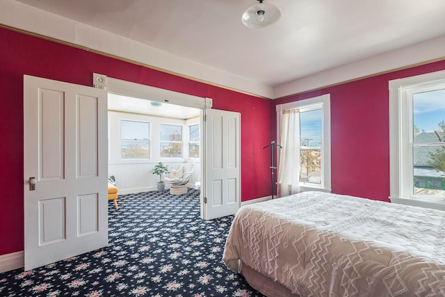 carpeted bedroom with multiple windows