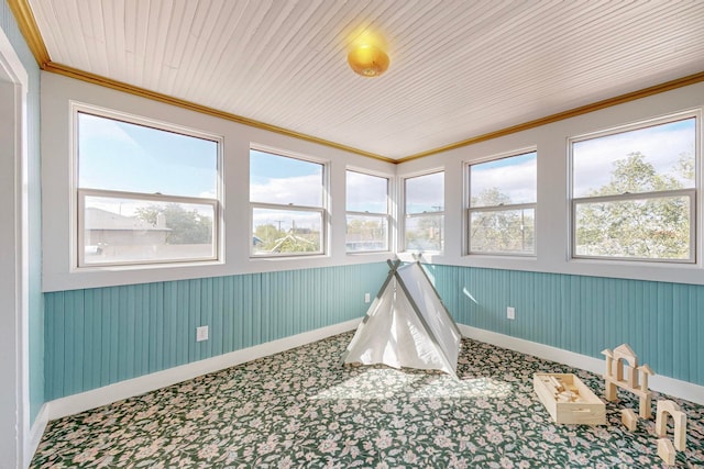 playroom with wood ceiling, carpet flooring, crown molding, and plenty of natural light