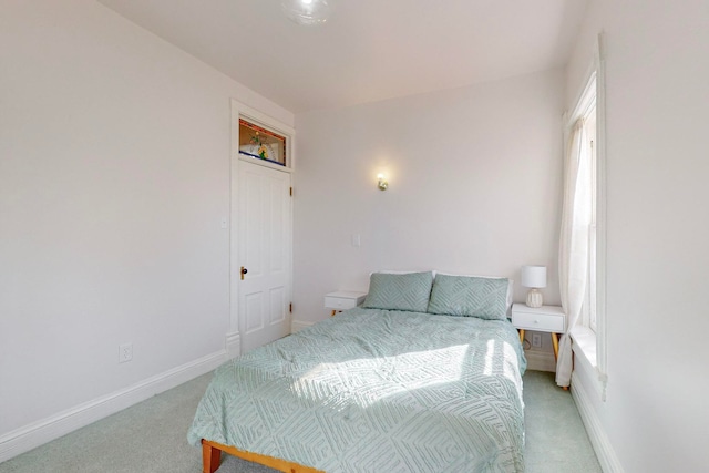 carpeted bedroom with multiple windows