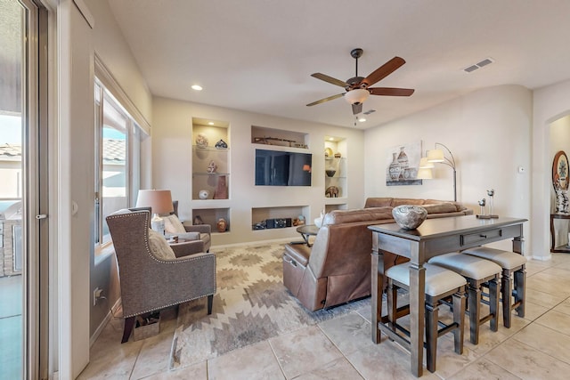 living room featuring light tile patterned flooring, built in features, and ceiling fan