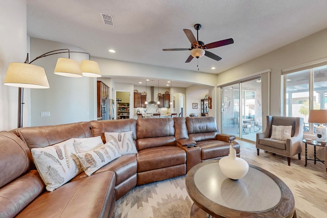 living room featuring light wood-type flooring and ceiling fan