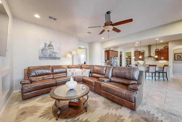 tiled living room featuring ceiling fan