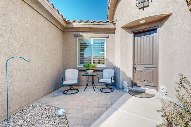 entrance to property featuring a patio area