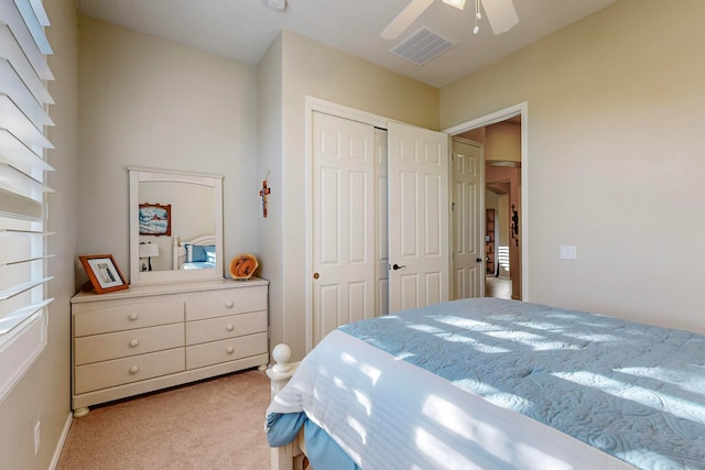 bedroom with light colored carpet, a closet, and ceiling fan