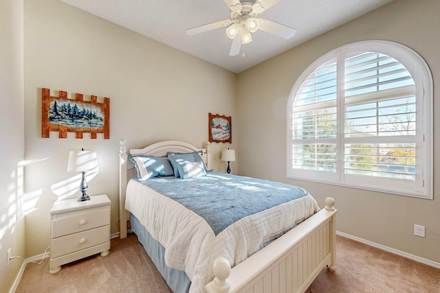 bedroom featuring light carpet, multiple windows, and ceiling fan