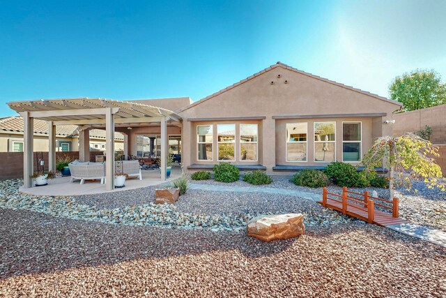 back of house with a patio area and a pergola