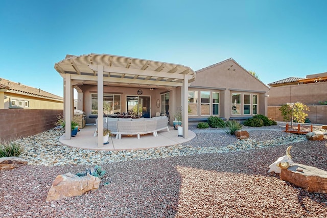 back of property with outdoor lounge area and a patio