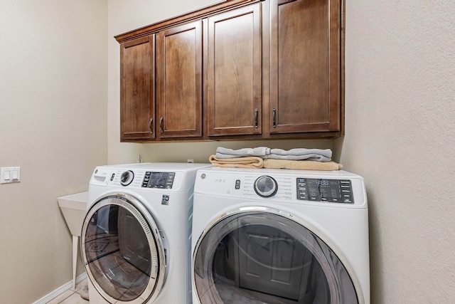 laundry area featuring cabinets and separate washer and dryer