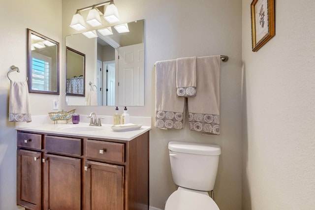 bathroom with toilet and vanity