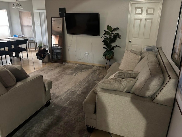 living room with tile patterned floors and a healthy amount of sunlight