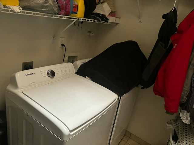 washroom featuring hookup for a washing machine and light tile patterned floors