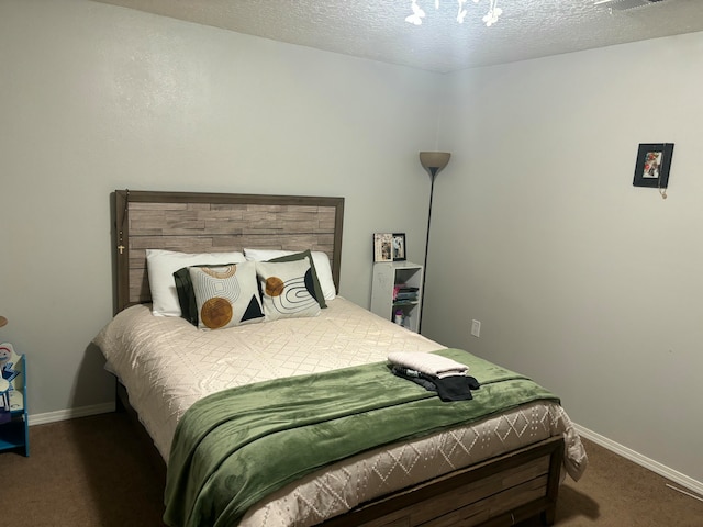 carpeted bedroom with a textured ceiling