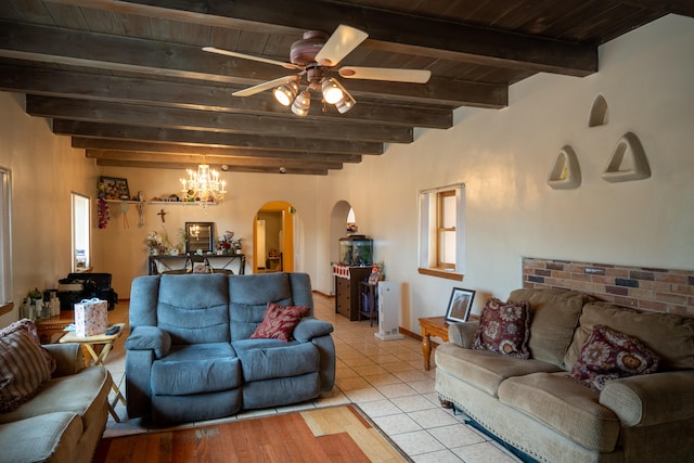 tiled living room with ceiling fan with notable chandelier, beam ceiling, and wooden ceiling