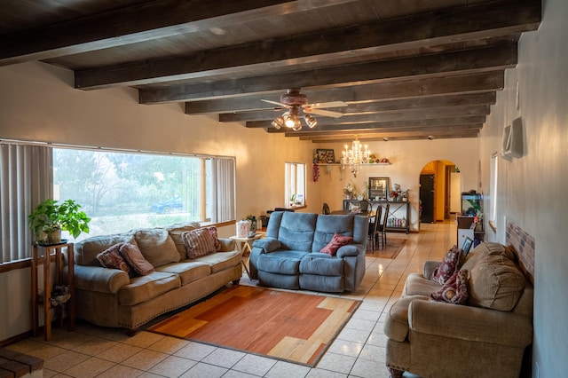 living room with beamed ceiling, wood ceiling, light tile patterned floors, and ceiling fan with notable chandelier