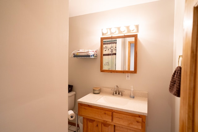 bathroom with toilet and vanity