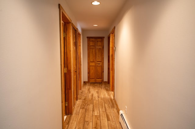 hallway featuring light hardwood / wood-style floors and baseboard heating