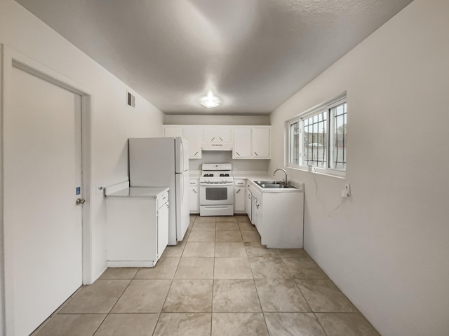 kitchen with white cabinets, white appliances, extractor fan, and sink