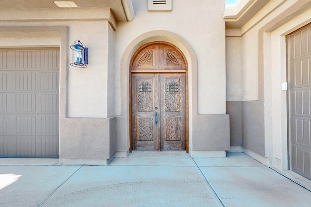 doorway to property with a garage