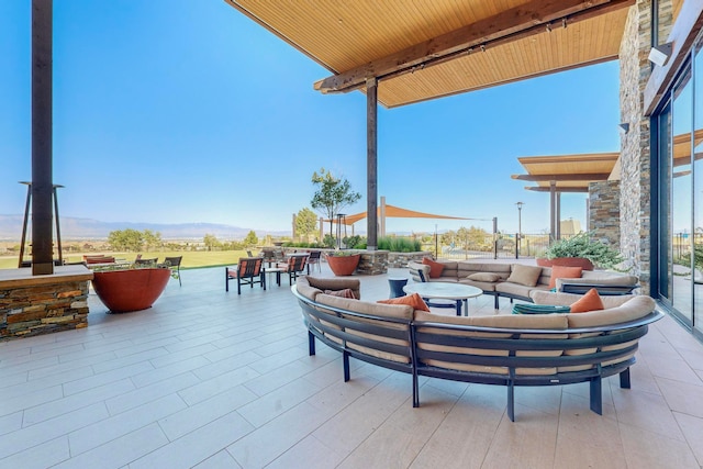 view of patio / terrace featuring an outdoor living space and a mountain view