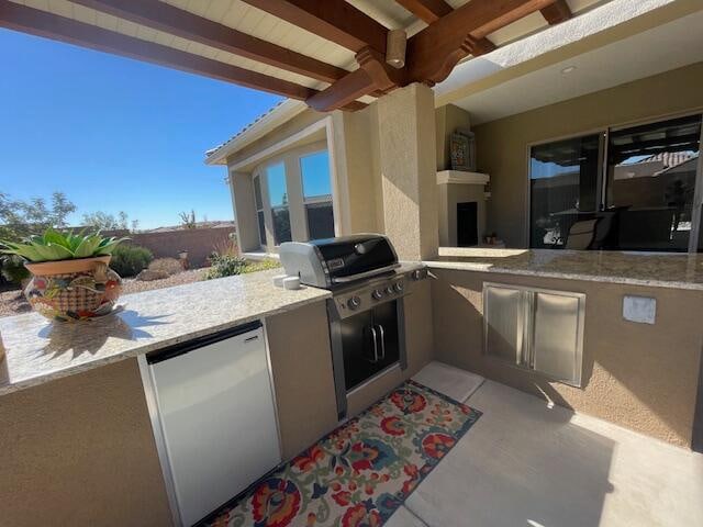 view of patio / terrace featuring area for grilling and an outdoor kitchen