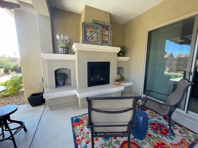 view of patio with an outdoor fireplace