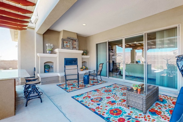 view of patio with a fireplace