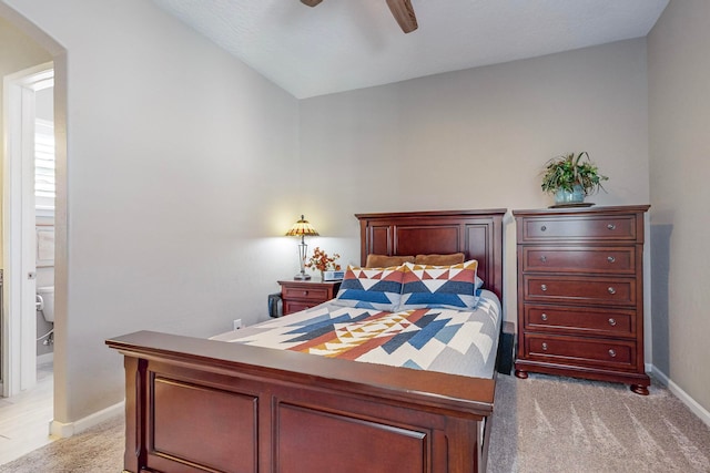 carpeted bedroom with lofted ceiling, ceiling fan, and connected bathroom