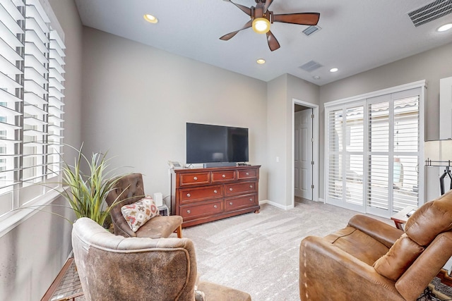 living room featuring light colored carpet and ceiling fan