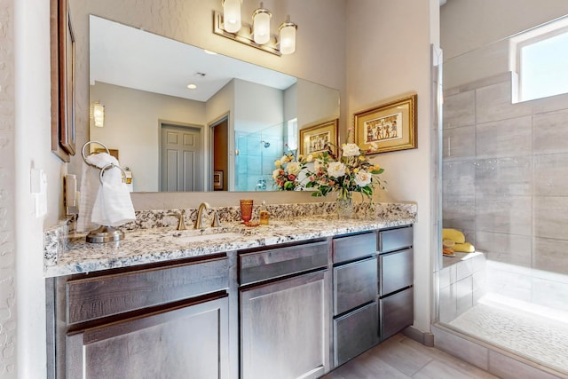 bathroom with walk in shower and vanity