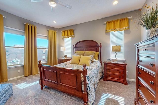 bedroom featuring light colored carpet and ceiling fan