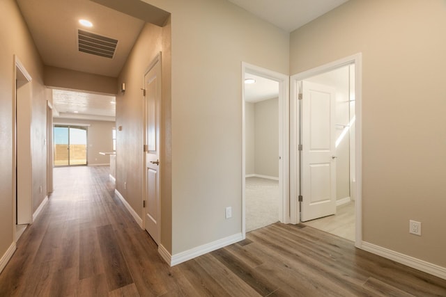 hall with wood-type flooring