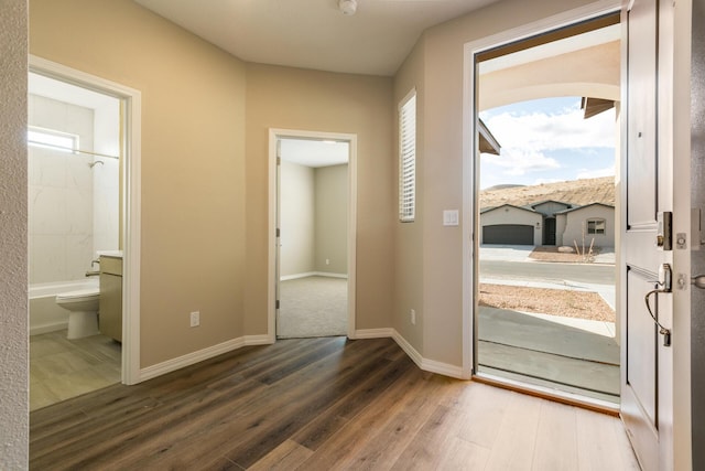 4860 Guadalupe Peak St SW, Los Lunas, NM 87031 - doorway featuring wood finished floors, healthy amount of natural light, and baseboards