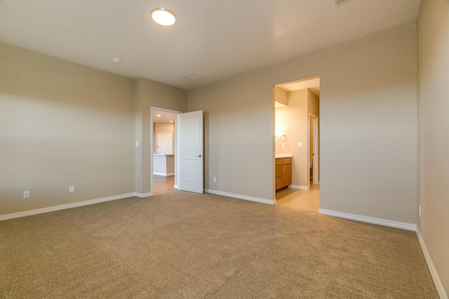 4860 Guadalupe Peak St SW, Los Lunas, NM 87031 - unfurnished bedroom with light carpet, baseboards, and ensuite bath