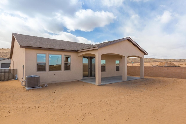 4860 Guadalupe Peak St SW, Los Lunas, NM 87031 - back of property with central AC, a patio area, a fenced backyard, stucco siding, and roof with shingles