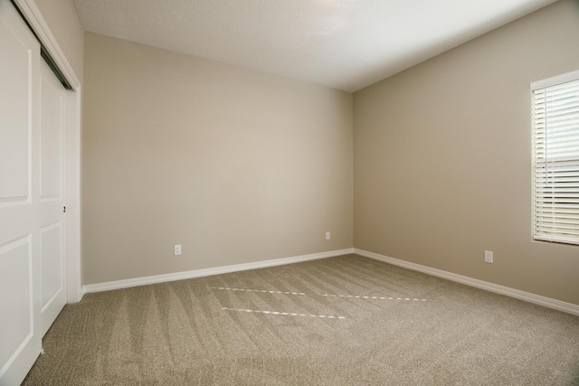 unfurnished bedroom with carpet floors and a closet