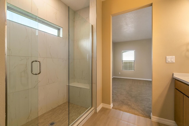 bathroom with a shower with door and vanity